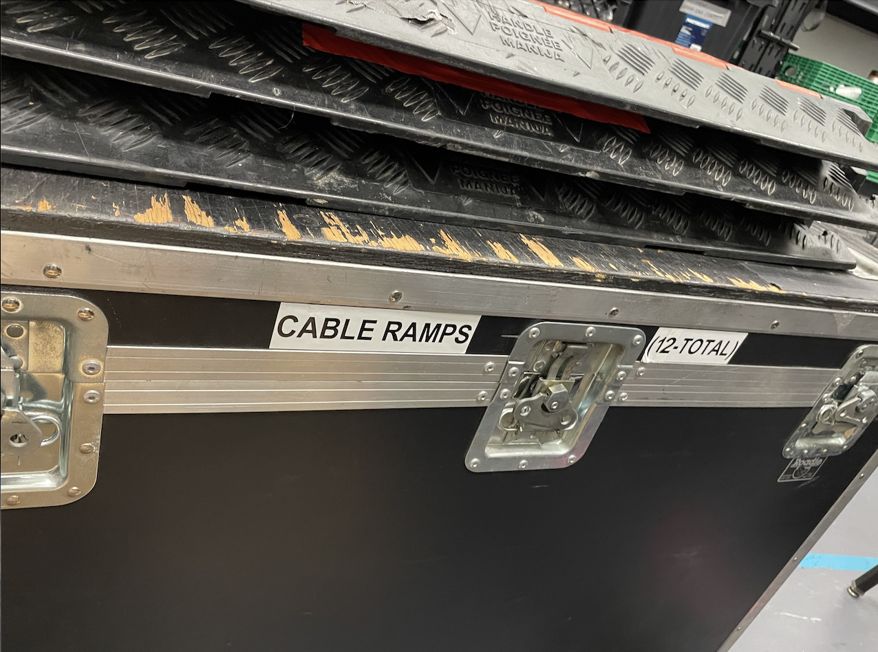 Home 3 A flight case labelled cable ramps- 12 total, with a couple of ramps stacked on top.